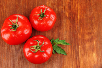 Fresh tomatoes on wooden background