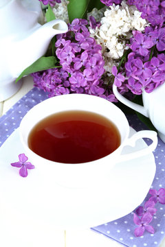 Composition with beautiful lilac flowers, tea service