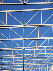 White steel structure of roof on the blue sky