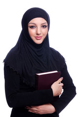 Young muslim woman with book on white