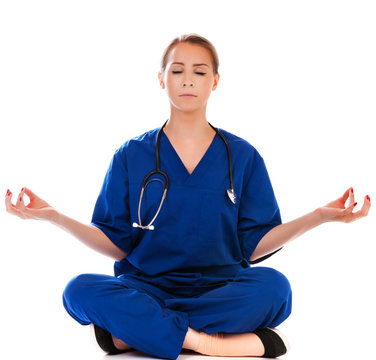 Pretty Nurse Doing Meditation Isolated On White