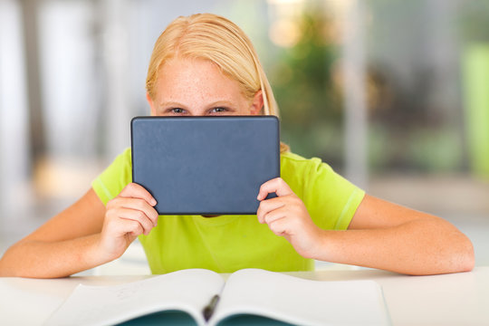 Funny Pre Teen Girl Behind Tablet Computer