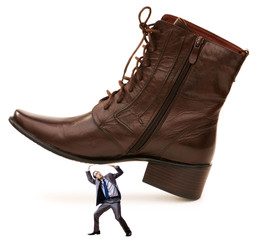 Woman domination concept with shoes and man