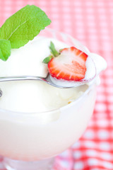 ice cream,strawberry with mint in a glass bowl on plaid fabric