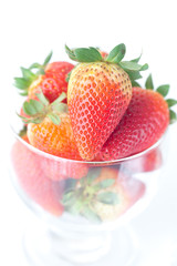 big red strawberries in a glass bowl