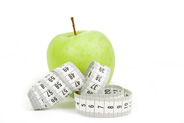 Measuring tape and green apples as a symbol of diet
