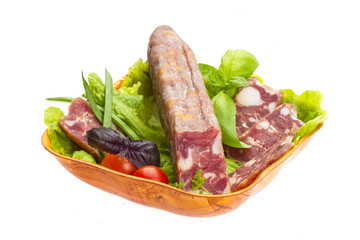 Ripe salami with salad, basil, onion and tomato