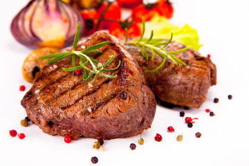 Grilled steaks isolated on white background 