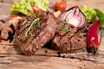 Grilled steaks on wood 