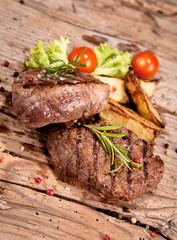 Grilled steaks on wood 