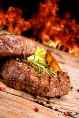 Grilled steaks on wood 