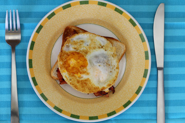 Fried egg and bacon on toast