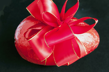 Gift-wrapped Easter Egg isolated on black