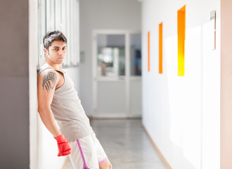 Boxer with red gloves in a gym