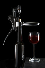 bottle with an opener  and a wine glass