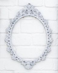 Vintage picture frame on white brick wall background