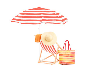 Sun lounger with orange stripes, umrella and summer accessories