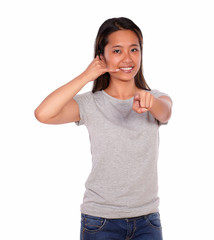 Asiatic young woman saying at you call me