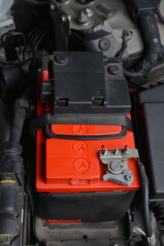 New car battery in motor space.