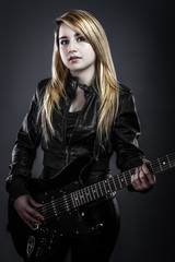 Fototapeta premium Teenager holding a black electric guitar