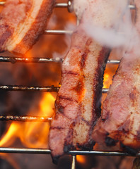 bacon meat on bbq  barbecue grill with fire