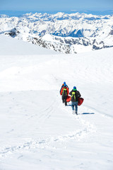 Fototapeta na wymiar A group of mountain hiker walking on the snow into the mountain