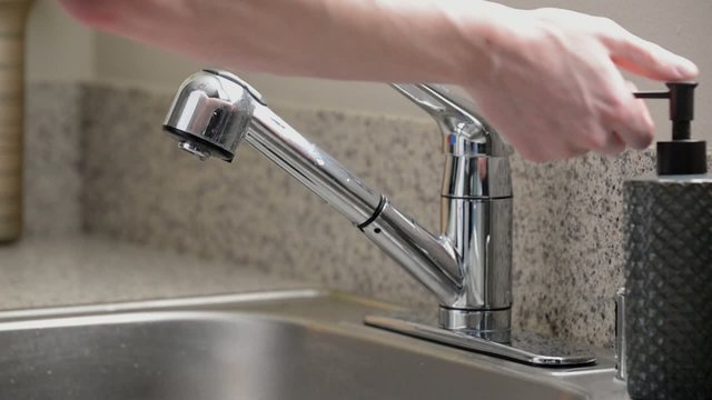 Close up man washing hands kitchen sink, slow motion, overcrank