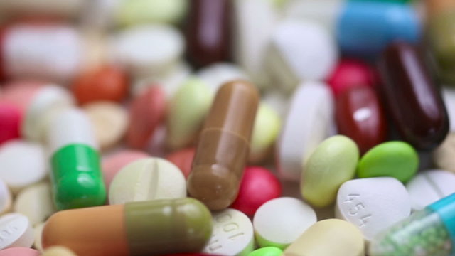 Colorful pills turning in seamless loop