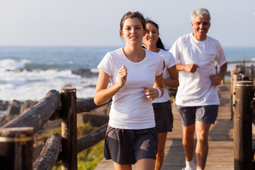healthy family jogging on beach