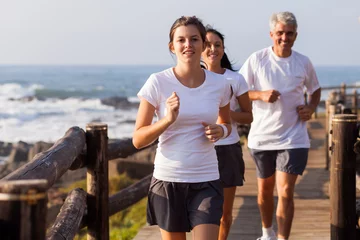Tuinposter healthy family jogging on beach © michaeljung