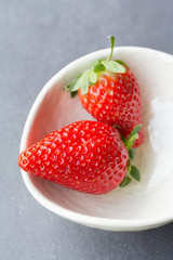 Two strawberries in bowl