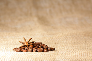 Coffee and Star Anise on sackcloth background with copyspace