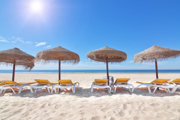 Parasols in a row on the beach near the sea. For the rest.