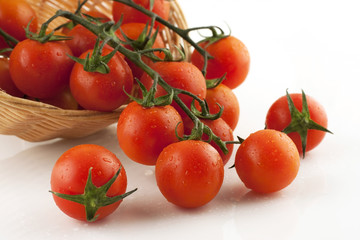 fresh tomatoes on the vine in  wicker basket