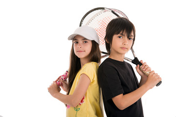 two happy children posing with tennis racquets on white backgrou