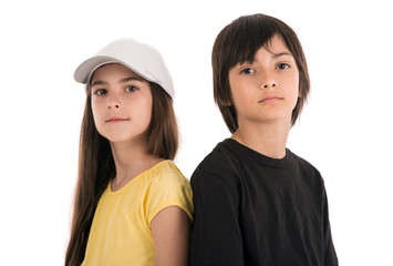 two children, boy and girl friends posing happily on white backg