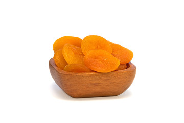 Dried apricots in a wooden bowl isolated on white