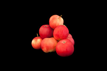 Pyramid of red apples isolated on black
