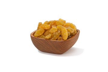 Yellow raisins in a wooden Pialat on white background