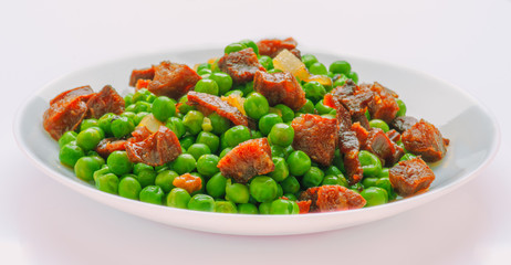 sauteed pea dish with ham and chorizo
