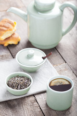 Fototapeta na wymiar Tea set with tea crop, croissants, teapot and mug.