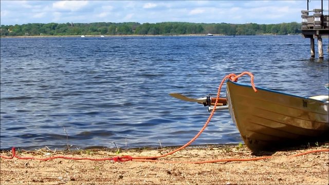 White rowboat laying on a beach