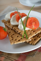 Fototapeta na wymiar Snack with mozzarella and crisp bread