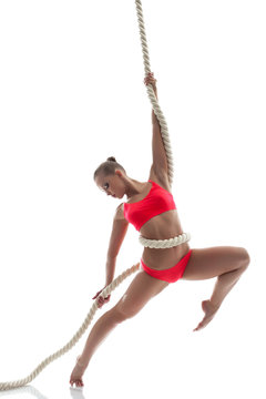 Graceful Woman Hanging On Rope In Studio