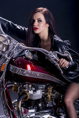 Fototapeta na wymiar Young woman on the motorcycle