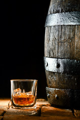 Glass of brandy alongside an oak barrel © exclusive-design