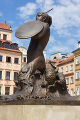 Symbol of Warsaw - mermaid over old Town colorful houses