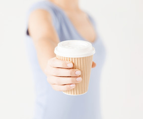 woman hand holding take away coffee cup