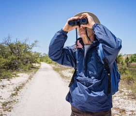 Man Hiking and Birdwatching, Looking Through Binoculars