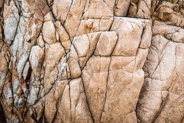 Solid limestone rock texture with muliple cracks